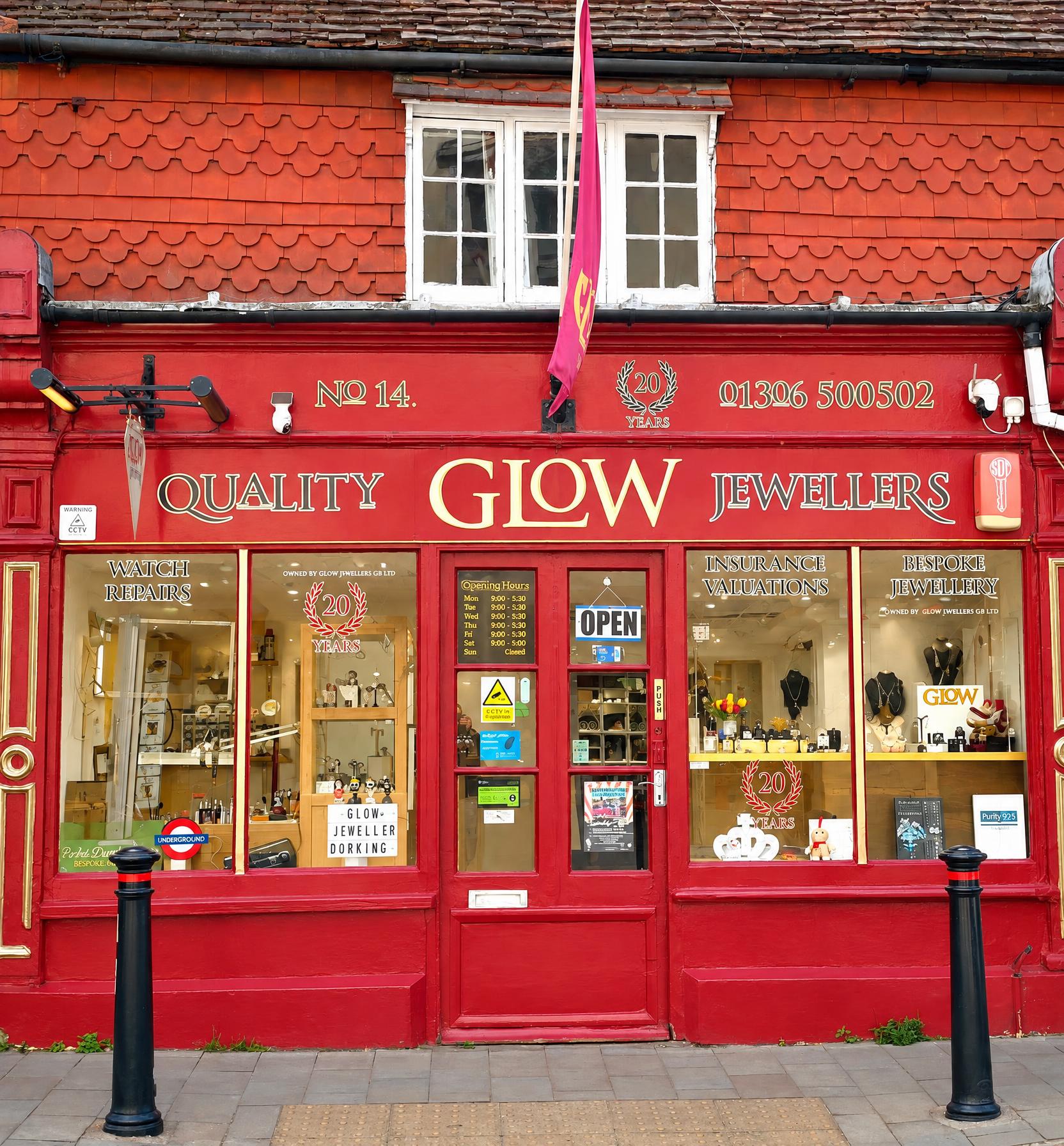 The Glow Jewellers shopfront at 14 West Street, Dorking, in daylight with the door sign showing open