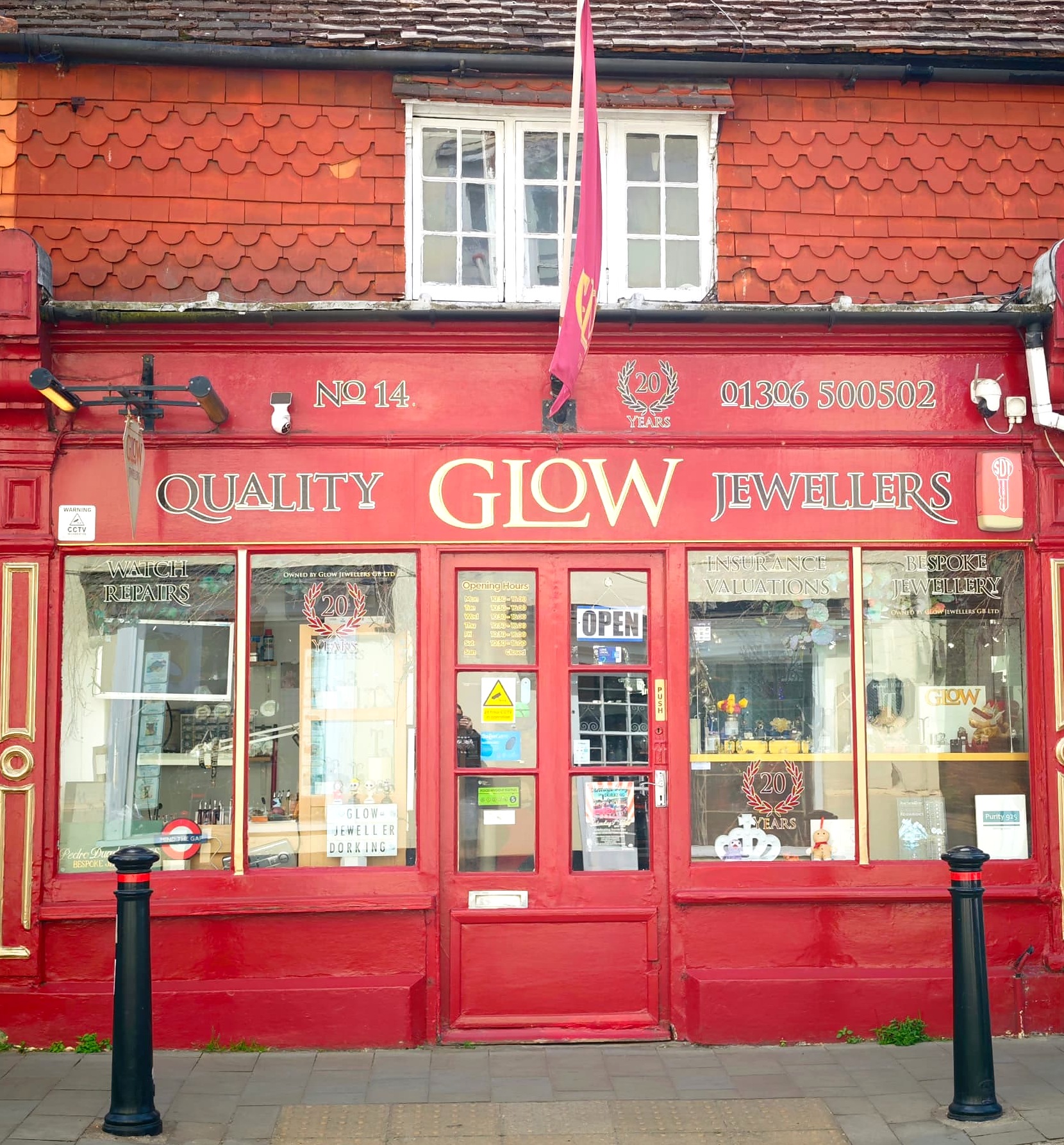 The Glow Jewellers shopfront at 14 West Street, Dorking, in daylight with the door sign showing open