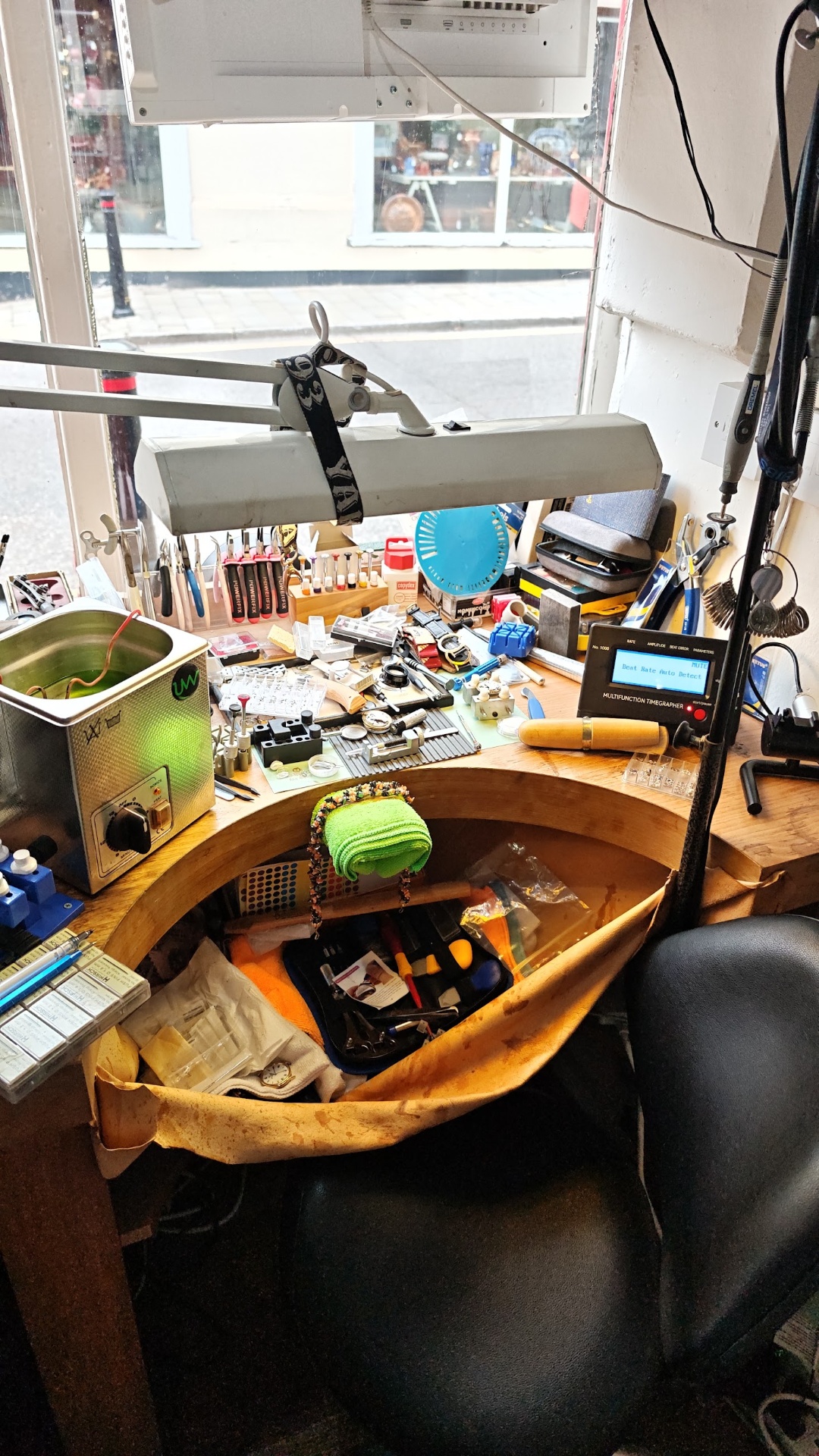 Watchmaker's bench at Glow Jewellers with a timegrapher, ultrasonic cleaner and a rack of precision tools